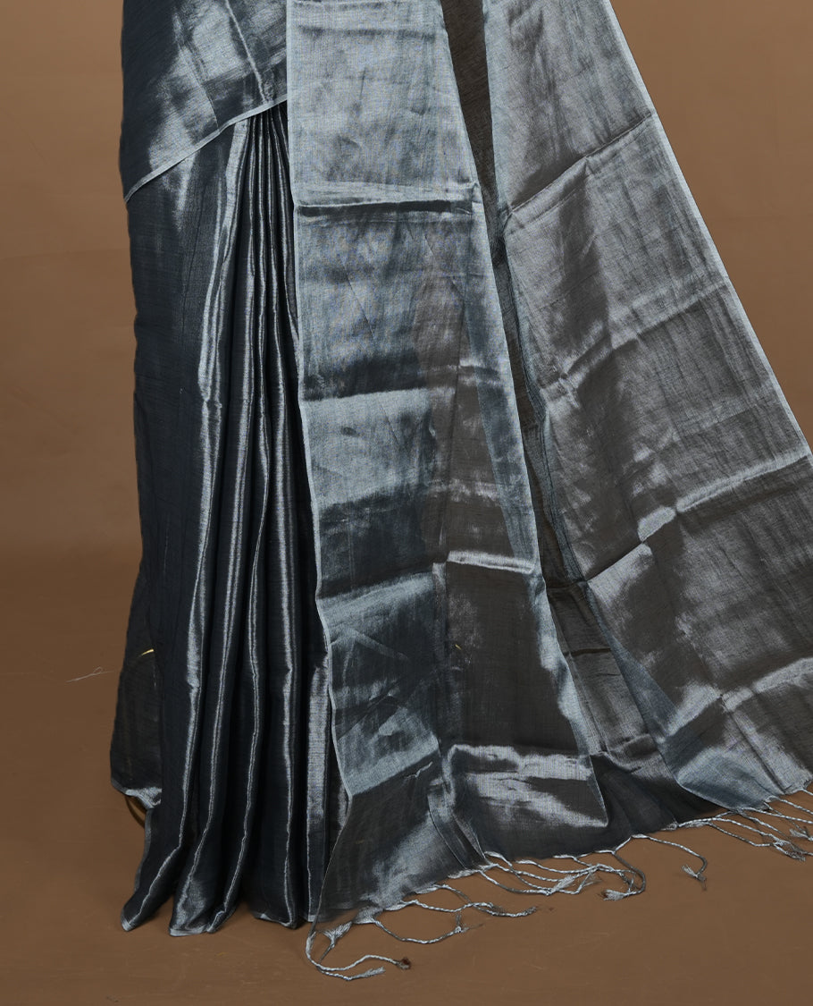 Silver colour semi tissue saree featuring an elegant plain body, designed without a border and comes without a blouse piece.