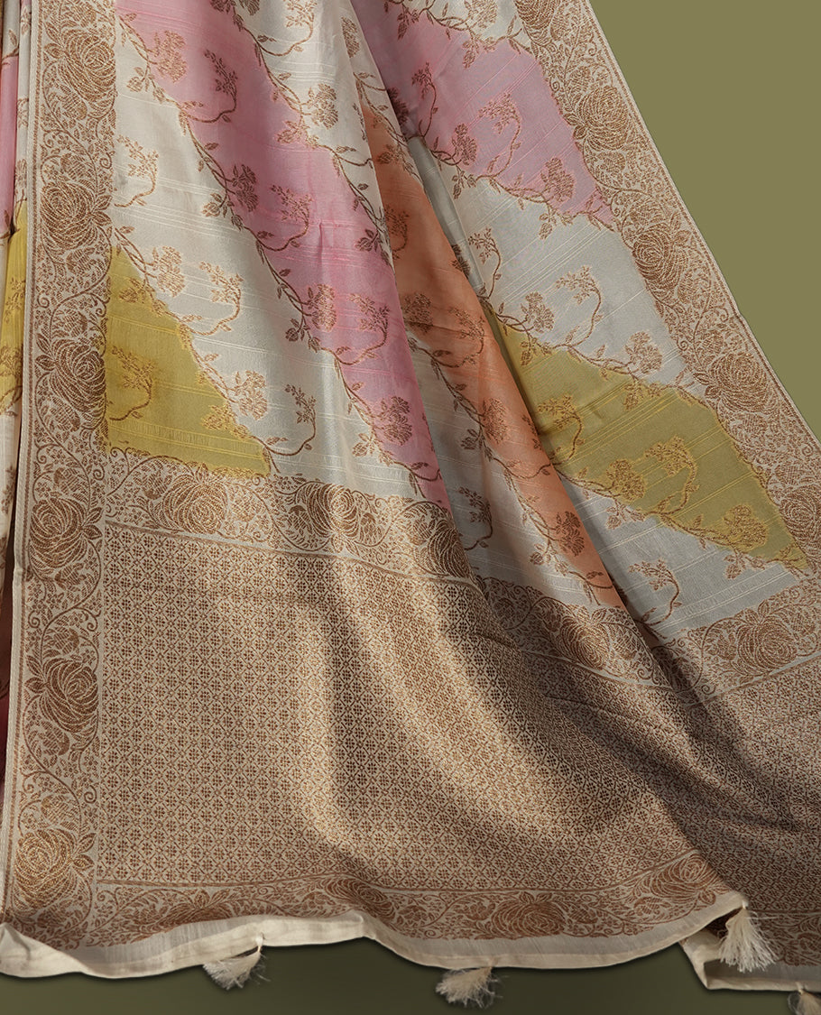 Pastel cream colour semi Banarasi Tussar Georgette saree with soft peach, lilac, and sage yellow floral motifs, antique gold zari border, and intricately woven pallu. Comes with matching blouse piece.