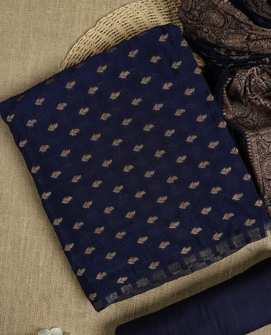 Navy blue suit material adorned with intricate light copper toned zari motifs weaving, exuding timeless elegance & Paired with a beautifully woven dupatta featuring floral and motifs and a matching plain bottom.