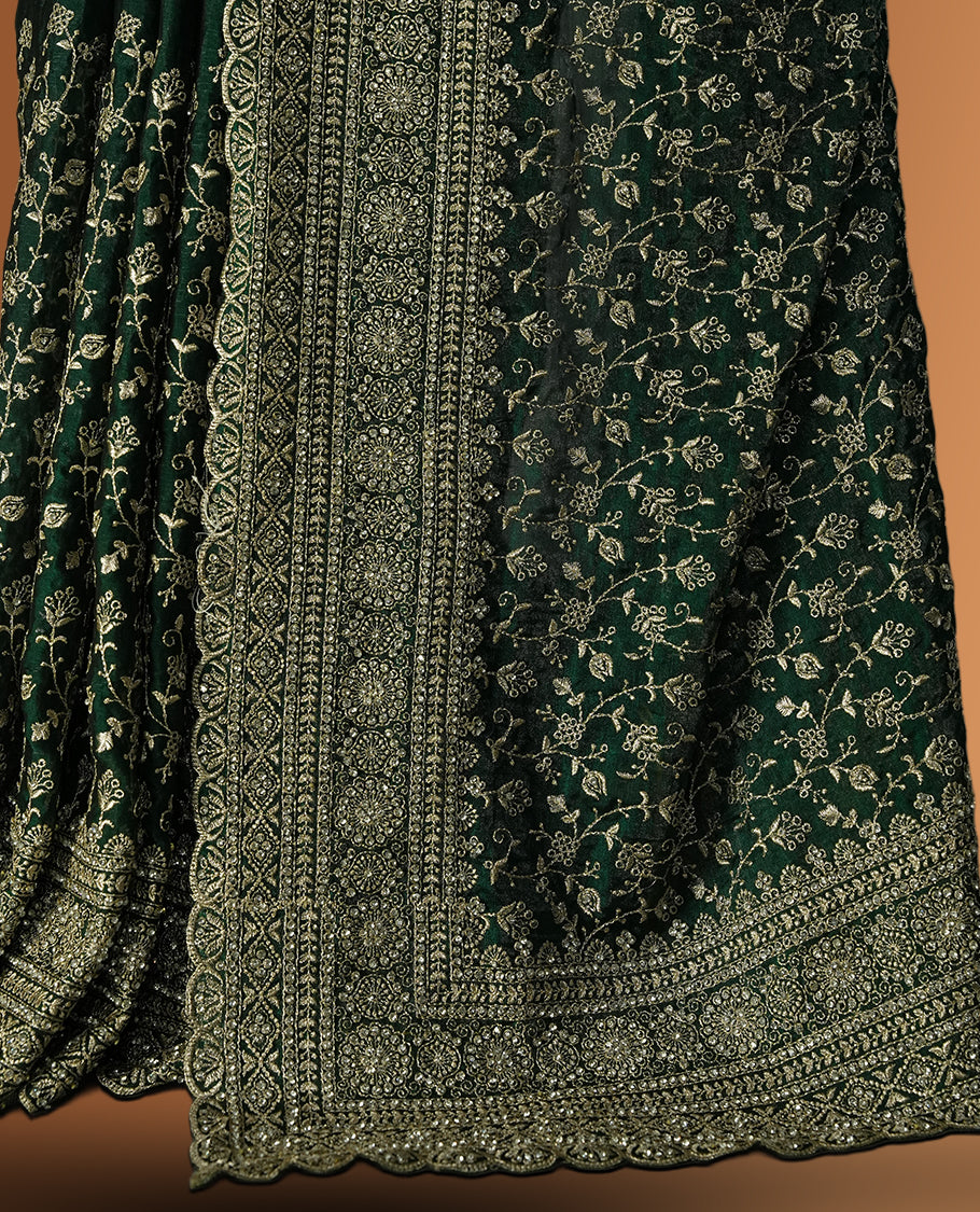Royal Green colour velvet chiffon designer saree in elegant two tone shades, featuring light gold zari, kodi work with handwoven style thread aari & dori embroidery work, Swarovski stone work and all over motifs, comes with matching blouse.