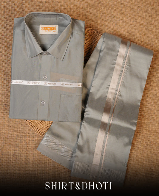 Grey colour shirt and dhoti with silver colour border, paired with matching colour silk saree featuring gold zari buttas and traditional border paired with matching blouse piece.