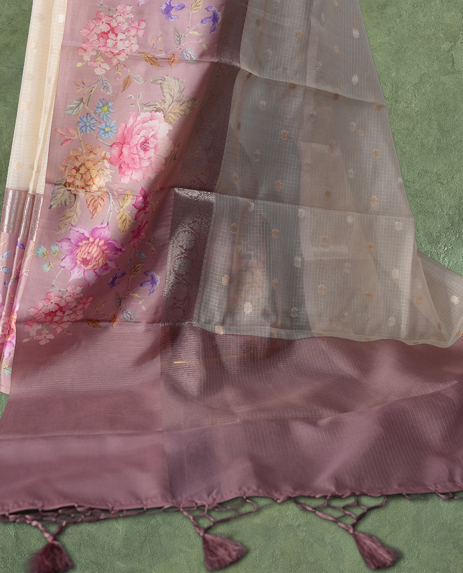 Ivory colour Kotta Tussar Silk saree features a vibrant digital floral print with small gold zari motifs on the body, and elegant pink colour banarasi border & Paired with a matching blouse,blending modern design with traditional elegance.