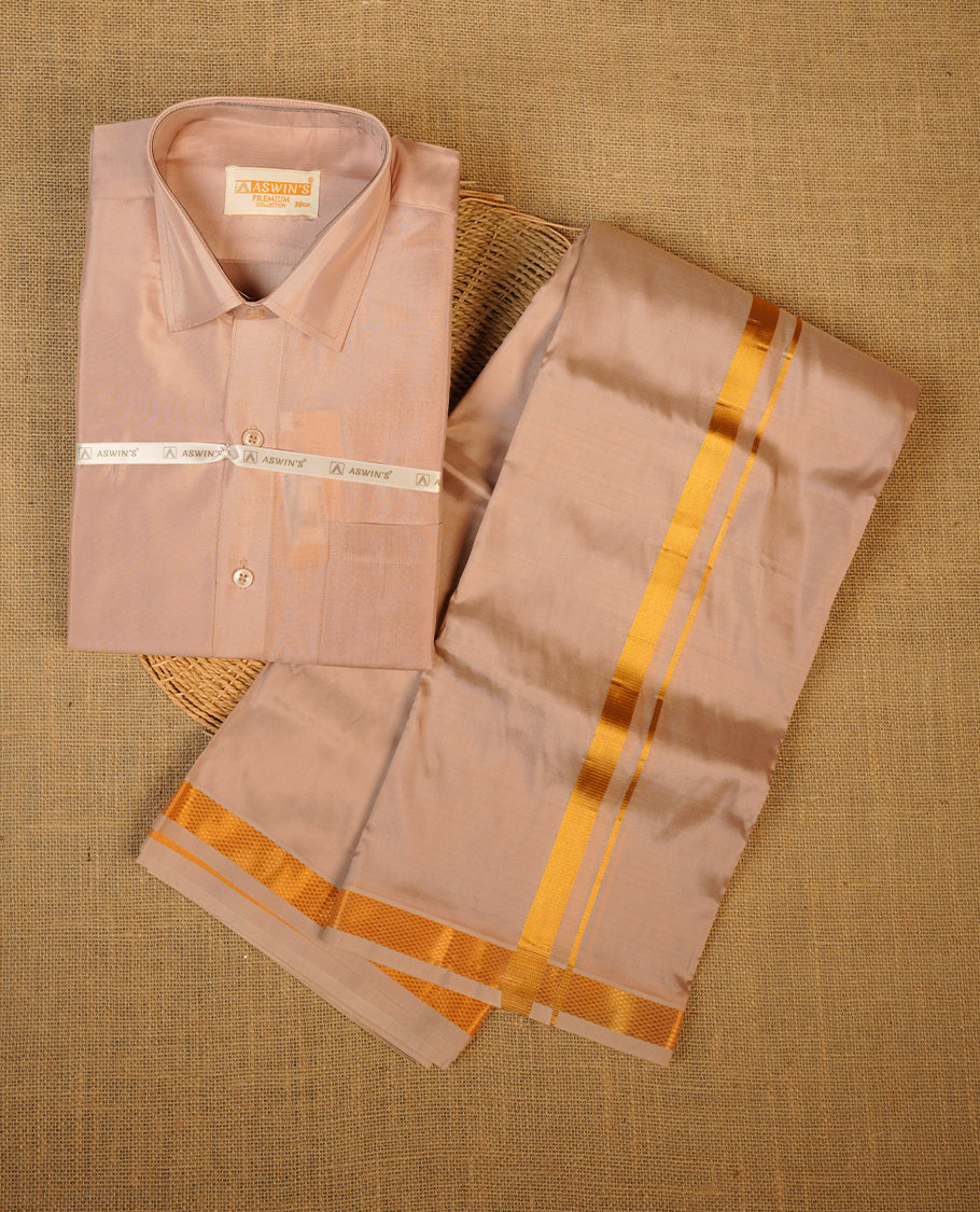 Sandstone colour shirt and dhoti with gold colour border, paired with matching colour silk saree featuring gold zari buttas and traditional border paired with matching blouse piece.