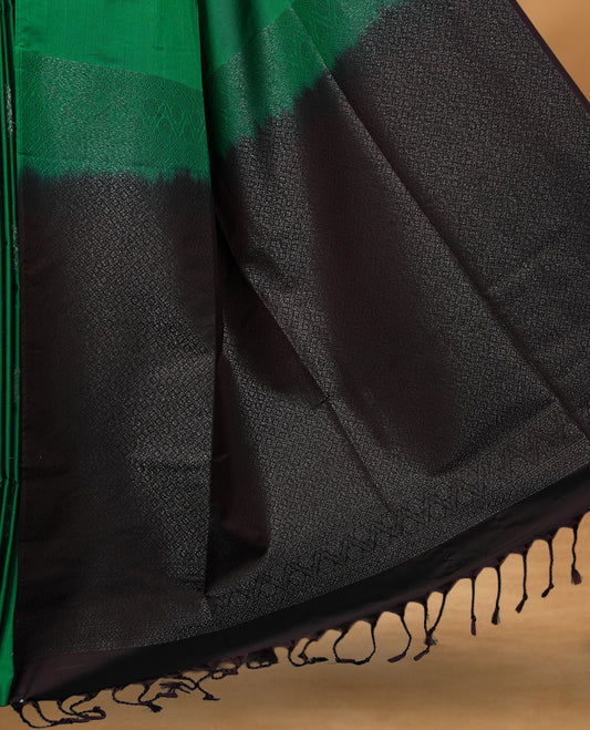 Green colour soft silk saree featuring Antique zari motifs on body with Highlighting contrast Deep Plum colour pallu and paired with matching blouse piece.