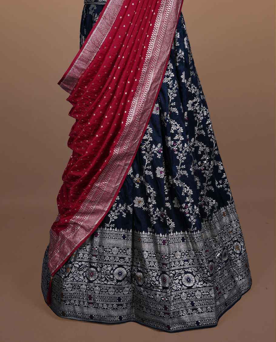 Teal colour semi banaras semi stitched dhavani set featuring gold zari floral kodi motifs and traditional border, unstitched matching blouse piece and contrast Red colour Duptta with silver zari border border.