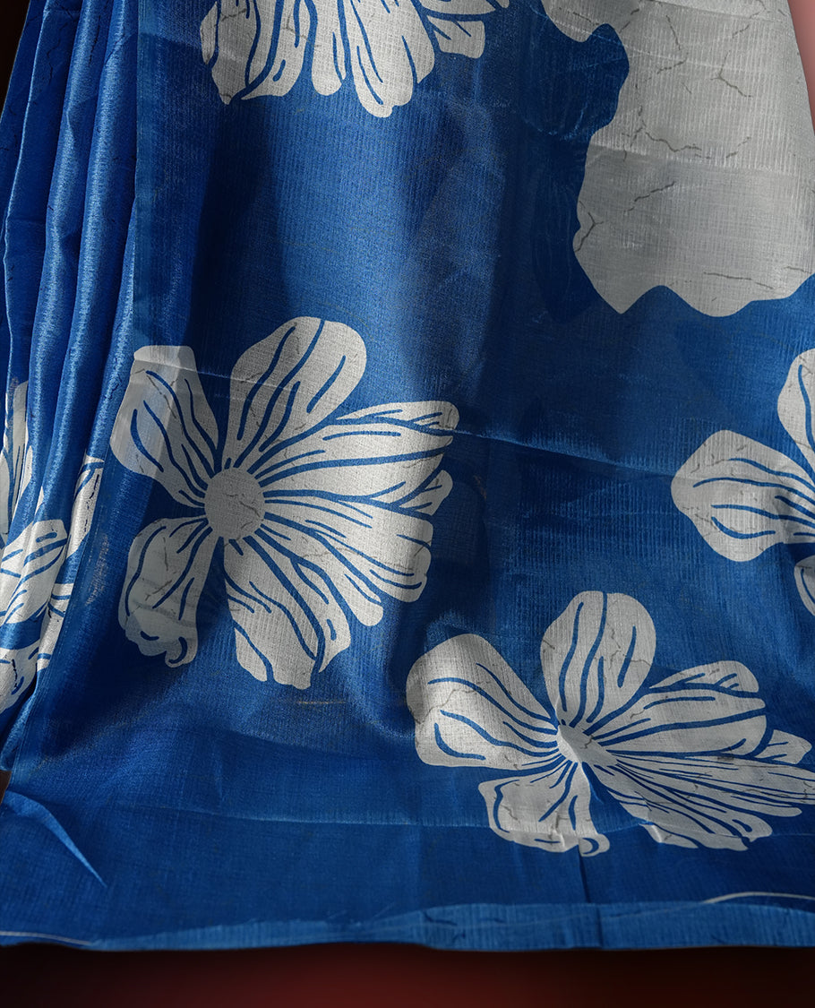 Sapphire blue colour semi khadi silk saree with off white floral motifs and subtle , exuding timeless elegance and modern charm & paired with a matching blouse.