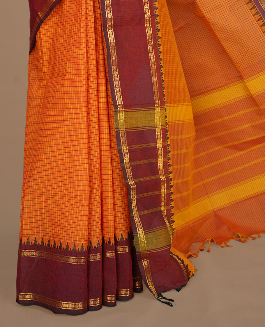 Tangerine colour chettinad colour featuring check pattern on body, complemented by maroon with zari border, paired with matching blouse piece.