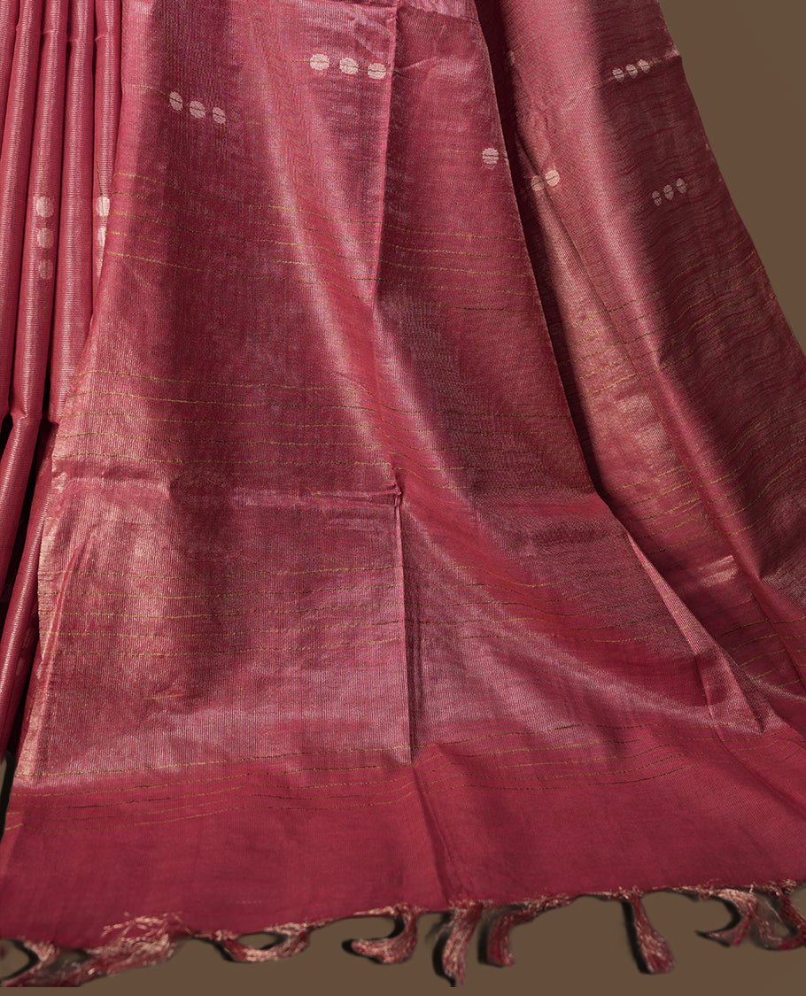 Onion pink colour semi jute saree featuring subtle dotted woven patterns on the body, complemented by a shimmering pallu & Comes with a matching blouse piece for a complete look.