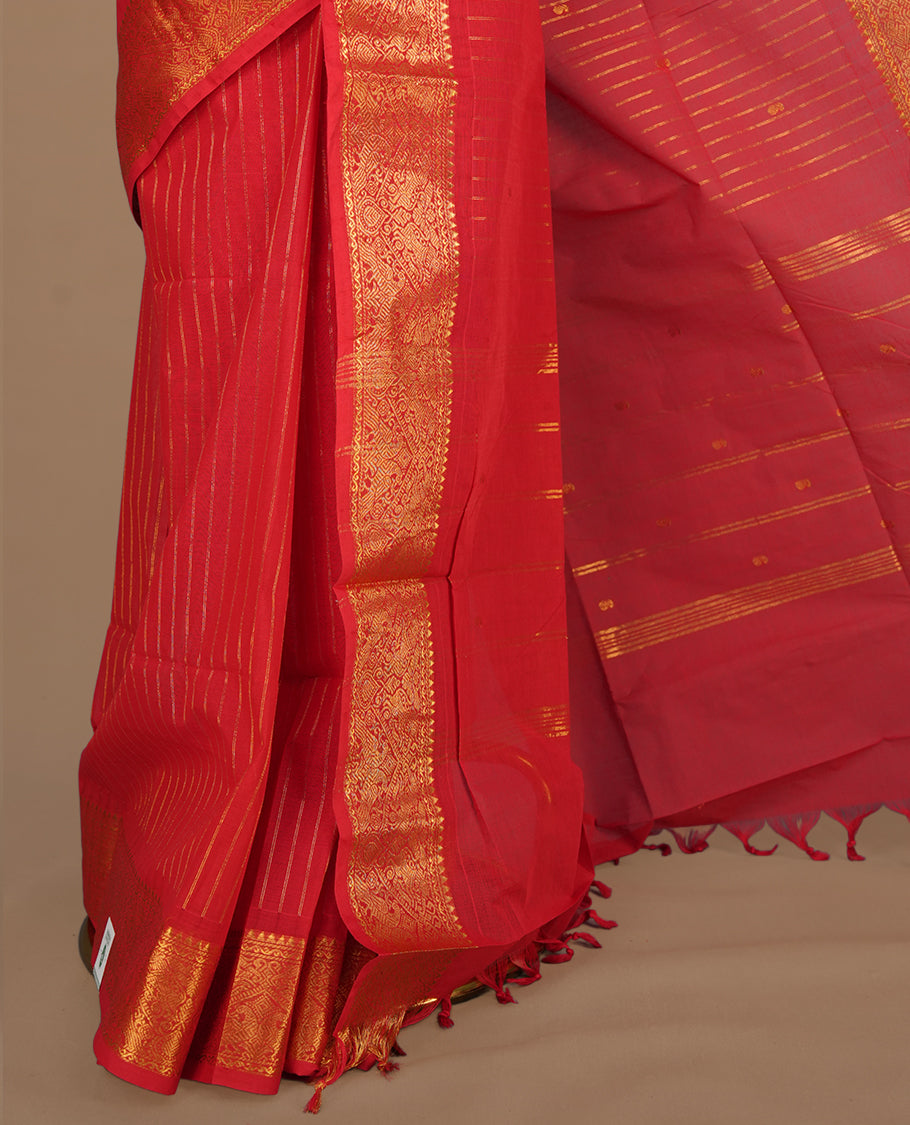 Red colour chettinad cotton saree featuring gold zari stripes on body, self colour with zari border, paired with matching blouse piece.