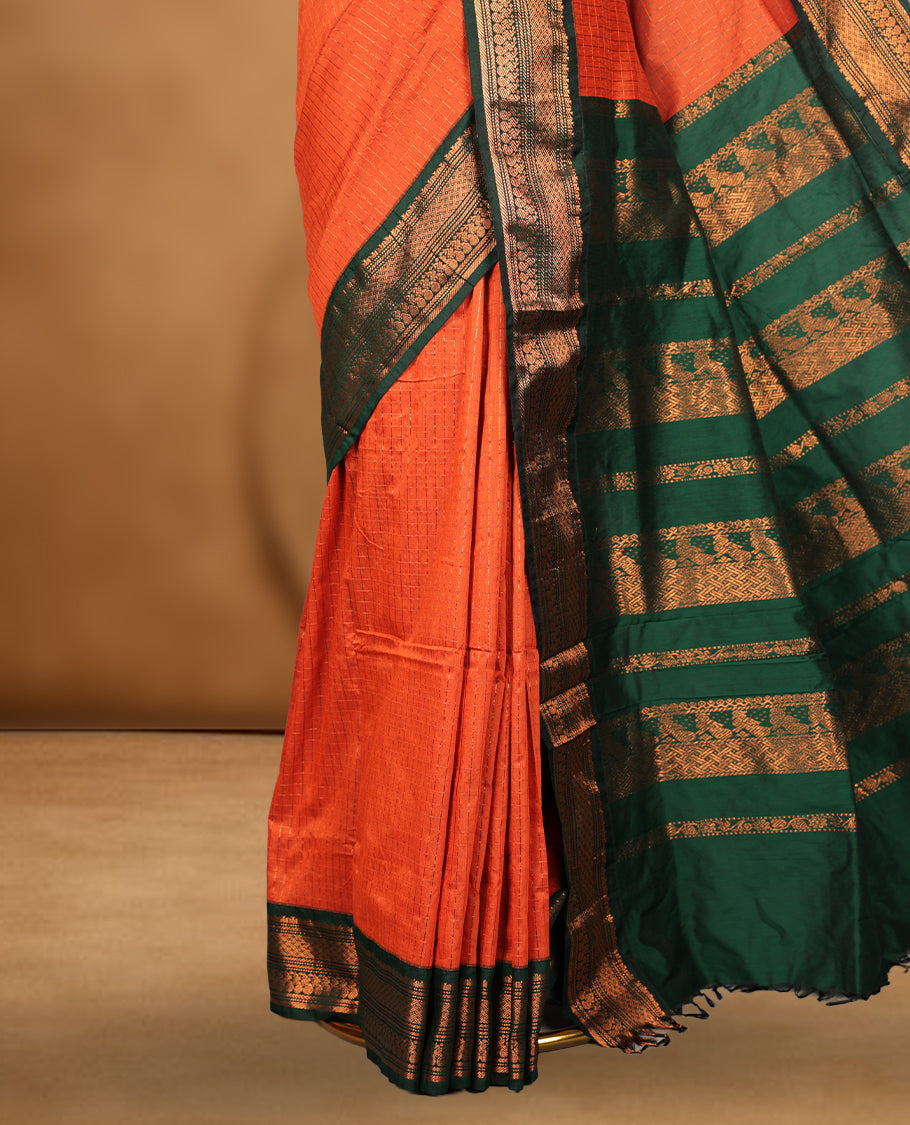Burnt orange colour kalyani cotton saree featuring Antique zari check pattern on body, contrast Green colour border with antique zari pattern, paired with matching blouse piece.