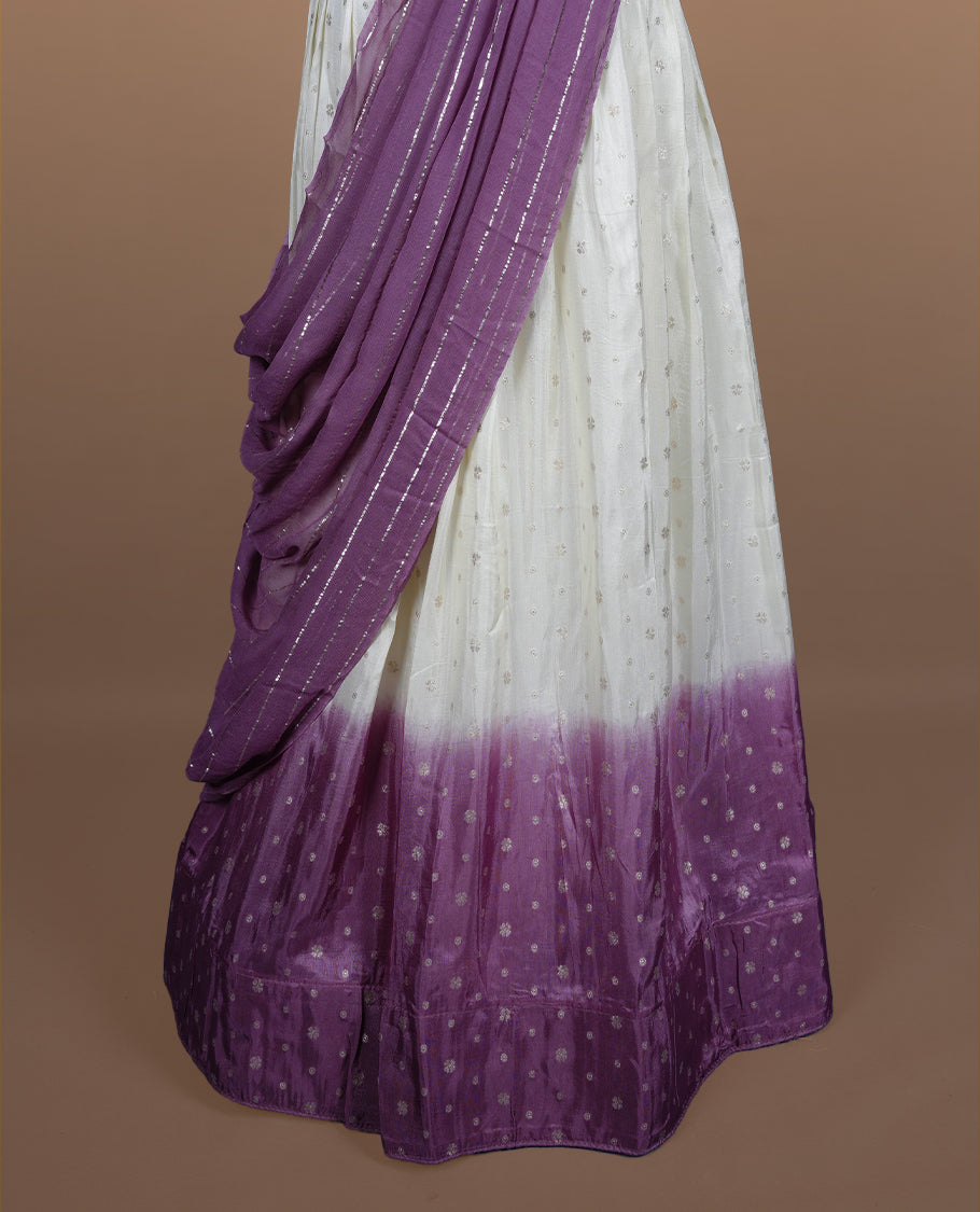 Off white semi banaras semi stitched dhavani set featuring gold zari motifs and contrast Purple colour border, unstitched gold zari blouse piece and matching Duptta with gold zari stripes.