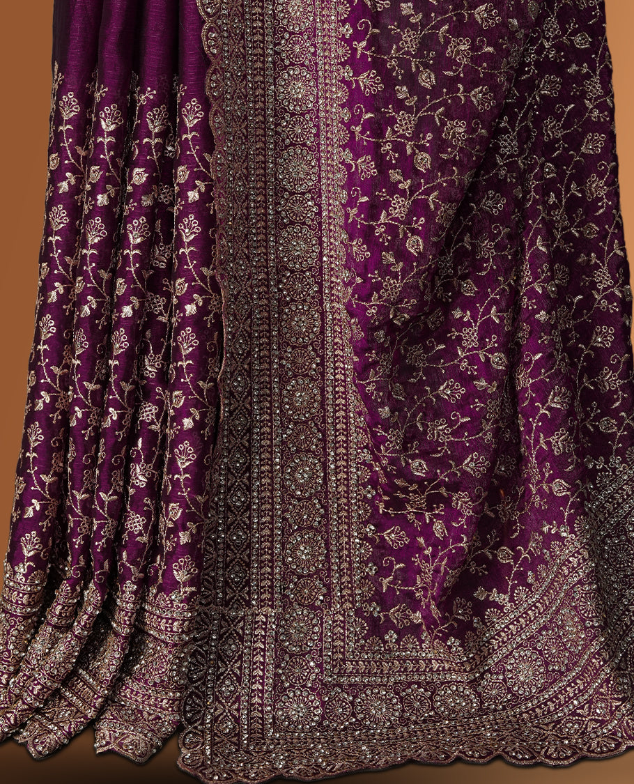 Magenta colour velvet chiffon designer saree in elegant two tone shades, featuring light gold zari, kodi work with handwoven style thread aari & dori embroidery work, Swarovski stone work and all over motifs, comes with matching blouse.