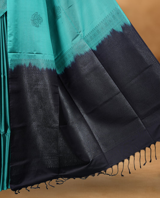 Teal colour soft silk saree featuring Antique zari motifs on body with Highlighting contrast Plum purple colour pallu and paired with matching blouse piece.