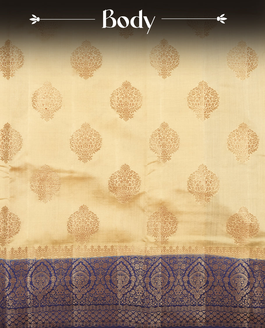Cream beige Banaras soft silk saree with gold zari oval motifs on body, with contrast Blue colour floral pattern on pallu, border, and Matching blouse.