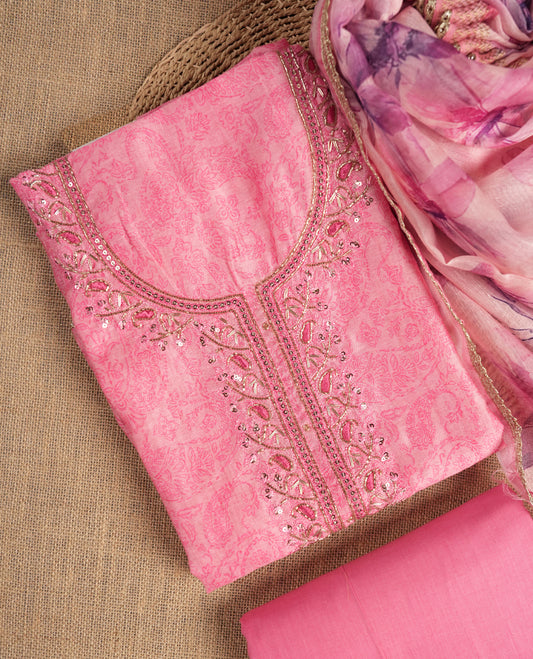 Pink colour suit material adorned with sequins and cut beads embroidery work on the neckline, exuding a graceful charm & Paired with a floral printed dupatta and a matching plain bottom.