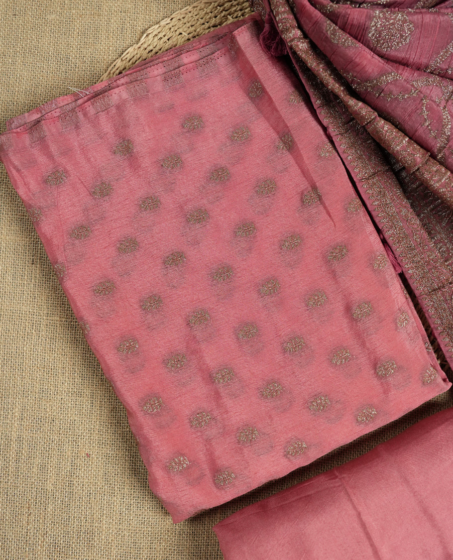 Dusty pink suit material adorned with delicate light copper toned zari work & Comes with a beautifully woven dupatta and matching plain bottom fabric.