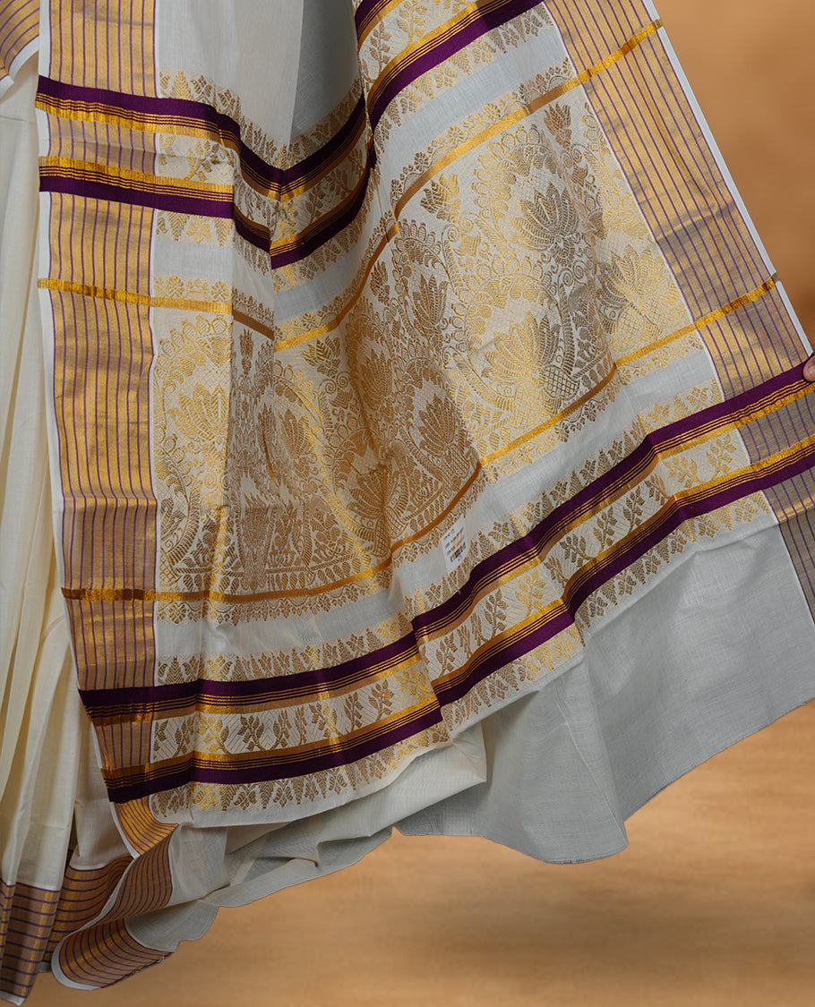 Off white Kerala saree with subtle woven motifs, striped zari border with purple accents, and rich traditional zari pallu, paired with a matching blouse.