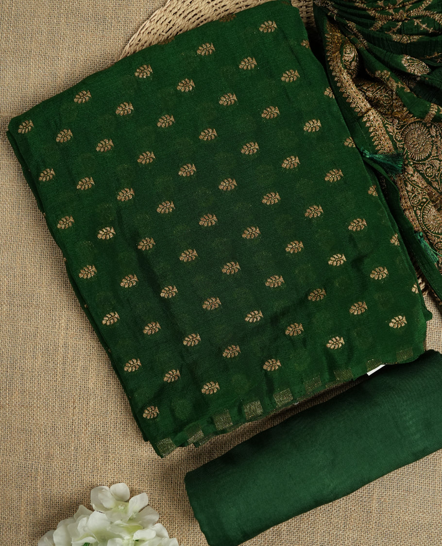 Royal Green suit material adorned with intricate golden toned zari motifs weaving, exuding timeless elegance & Paired with a beautifully woven dupatta featuring floral and motifs and a matching plain bottom.