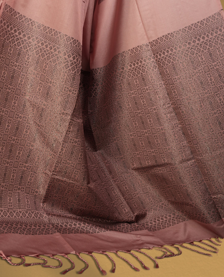 Soft peach colour semi soft silk saree, adorned with subtle woven floral motifs on the body & The design is elevated with an elegant zari border and pallu with tassels, paired with a matching blouse.