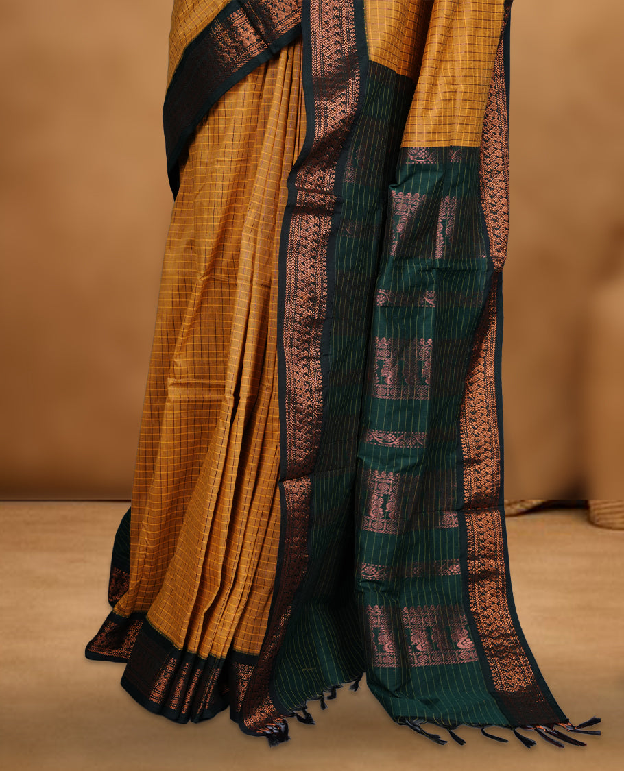 Mustard yellow colour mixed kalyani cotton saree featuring fine checked body, complemented by a dark green zari border and richly woven traditional pallu, paired with a matching blouse.