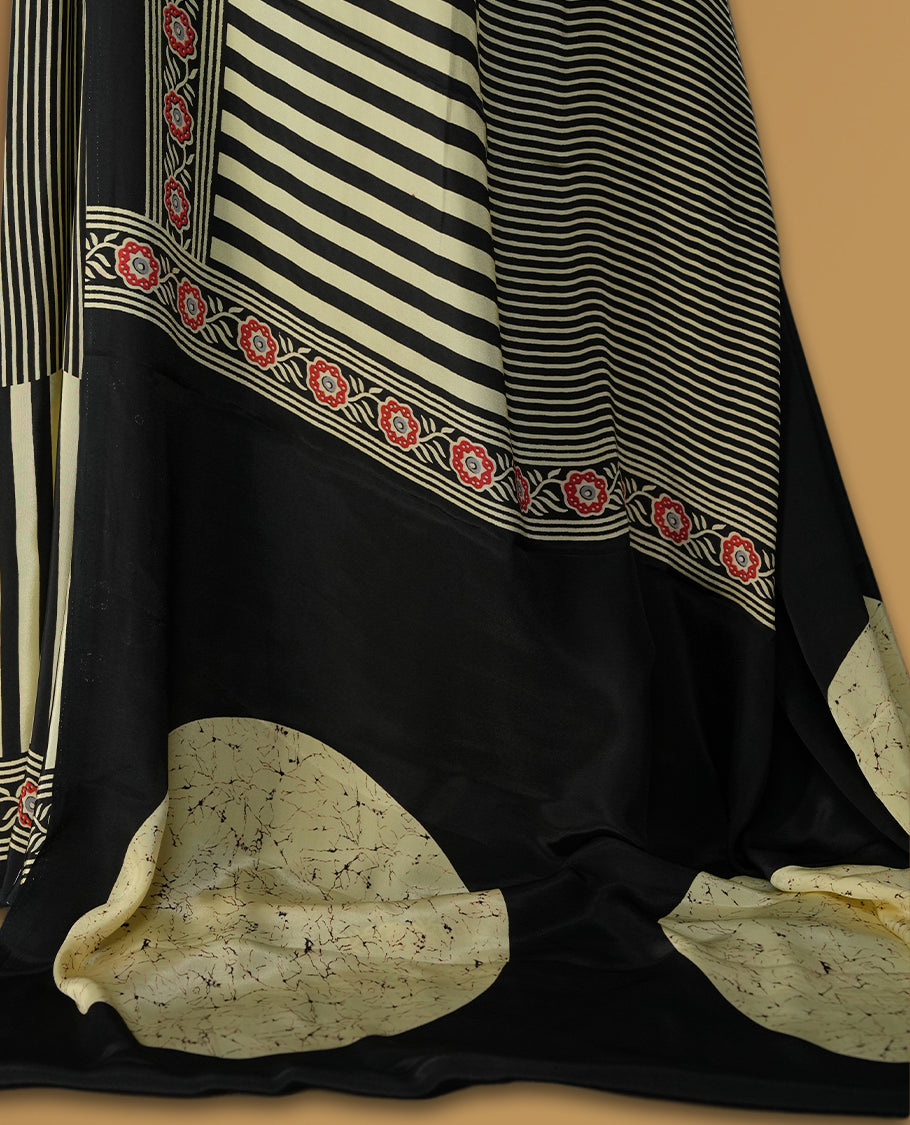 Black and beige colour striped saree with red floral embroidered border and abstract beige pallu detailing & Paired with a matching blouse.