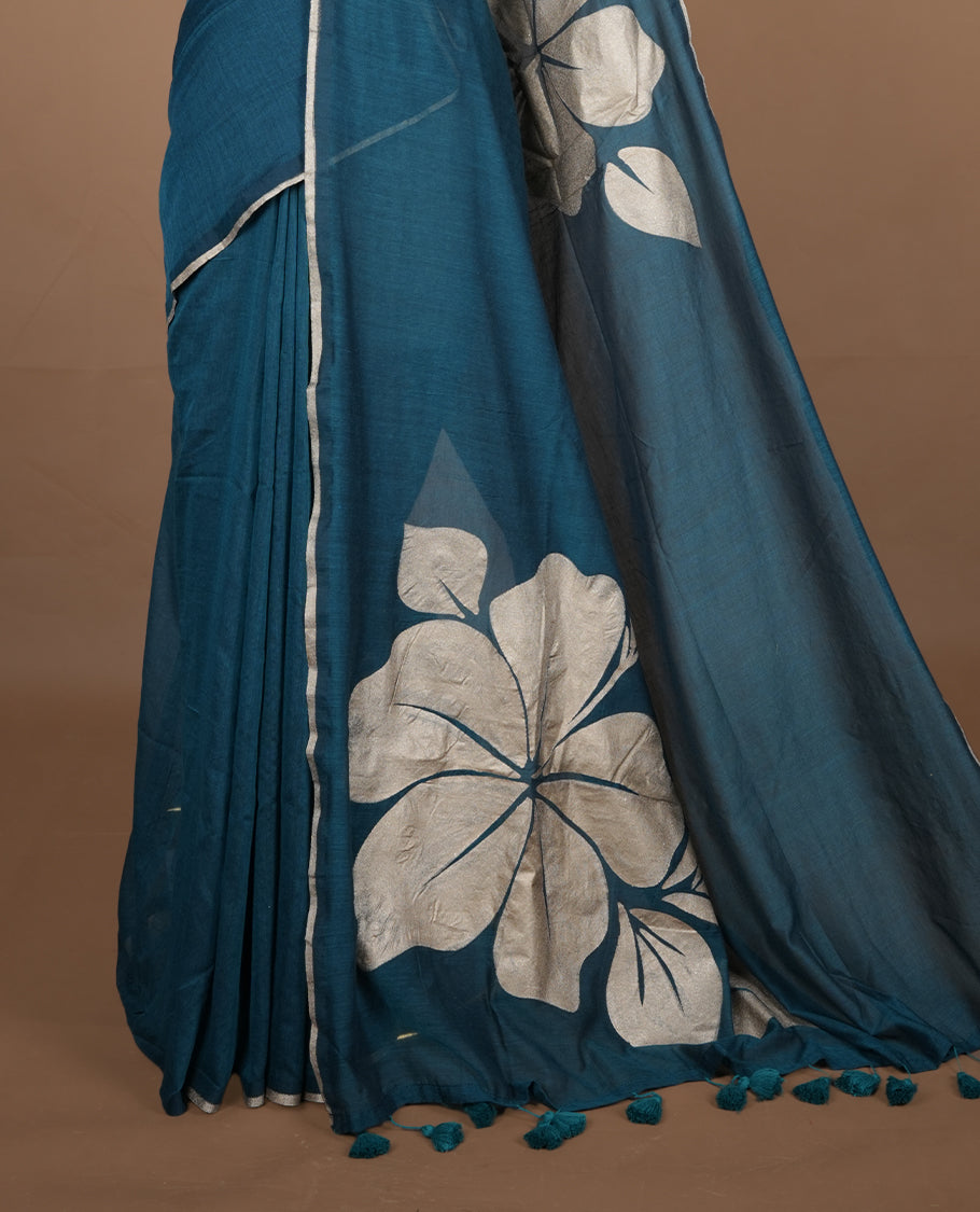 Green coloured mul cotton saree featuring bold gold-tone floral motifs across the body, designed without a border and comes without a blouse piece.