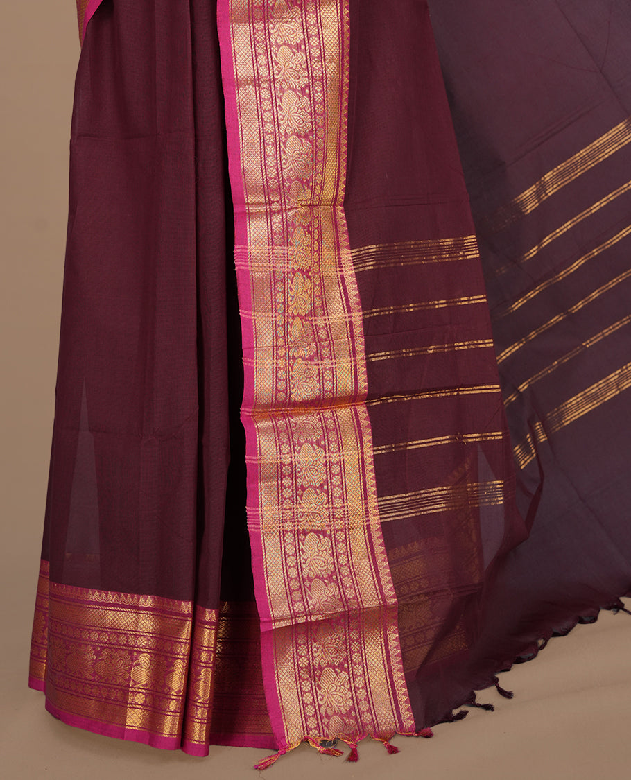 Maroon colour chettinad cotton saree featuring elegant plain body, complemented by contrast magenta colour with gold zari border, paired with matching blouse piece.