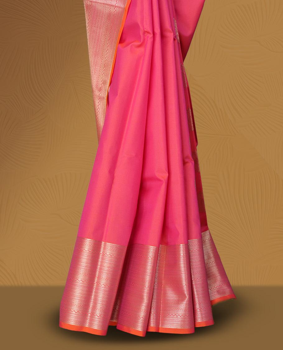 Pinkish peach colour body soft silk saree paired with a shimmering light peach & pink colour zari border & Adorned with elegant golden motifs and a matching blouse.