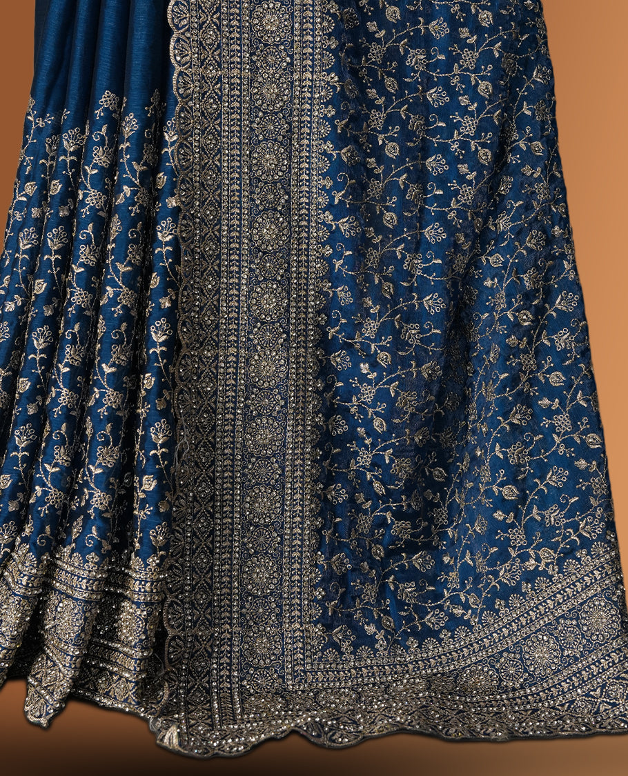 Royal blue colour velvet chiffon designer saree in elegant two tone shades, featuring light gold zari, kodi work with handwoven style thread aari & dori embroidery work, Swarovski stone work and all over motifs, comes with matching blouse.