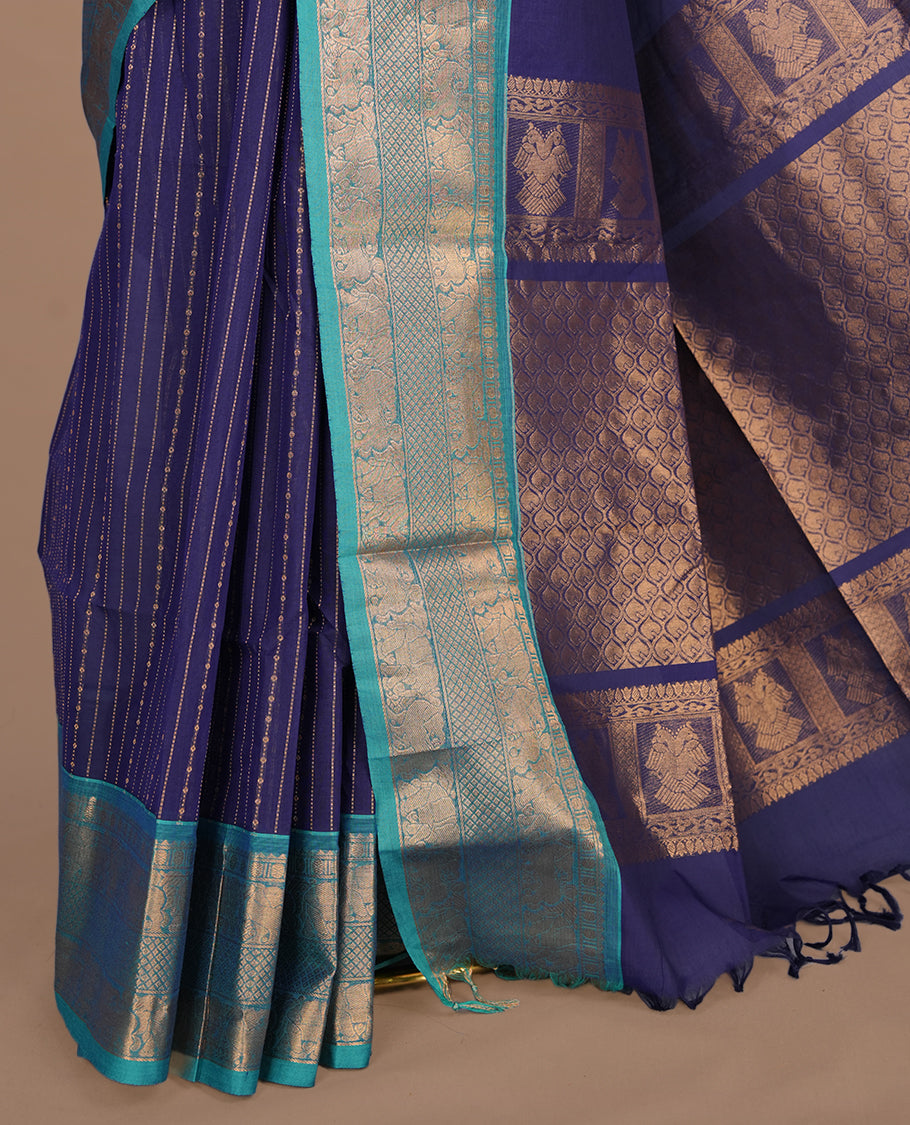 Navy blue colour chettinad saree featuring gold zari stripes on body, complemented by contrast Aqua colour with traditional border, paired with matching blouse piece.