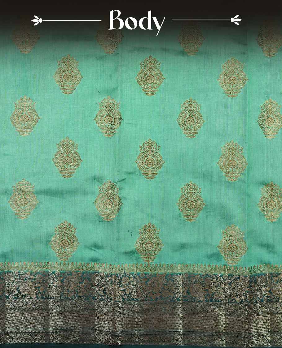 Teal Banaras soft silk saree with gold zari motifs on body, with contrast Dark teal colour floral pattern on pallu, border, and Matching blouse.