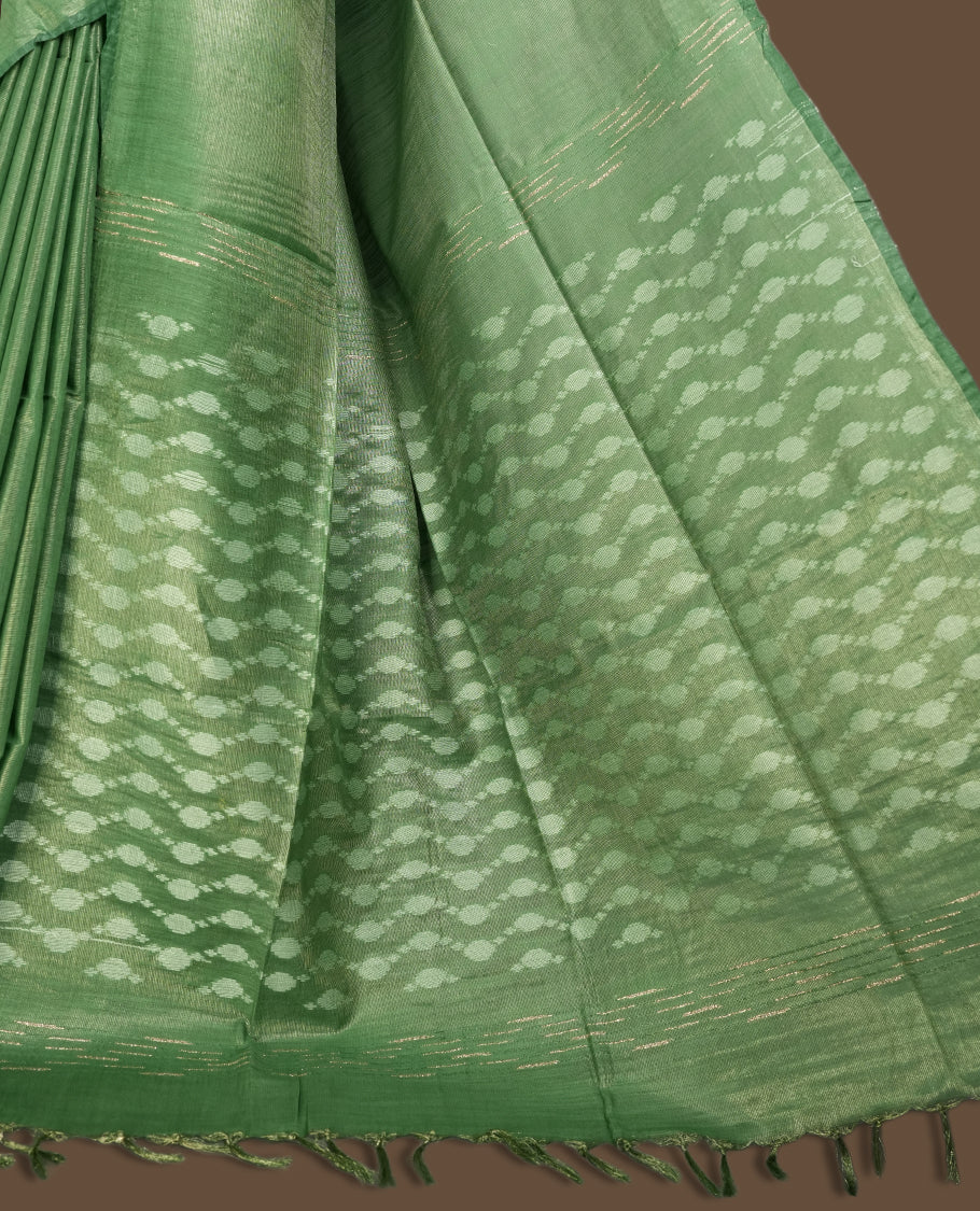 Pastel green colour semi jute tissue saree featuring subtle self weave patterns across the body, complemented by a delicately designed pallu with intricate geometric motifs & Comes with a matching blouse piece for a complete look.