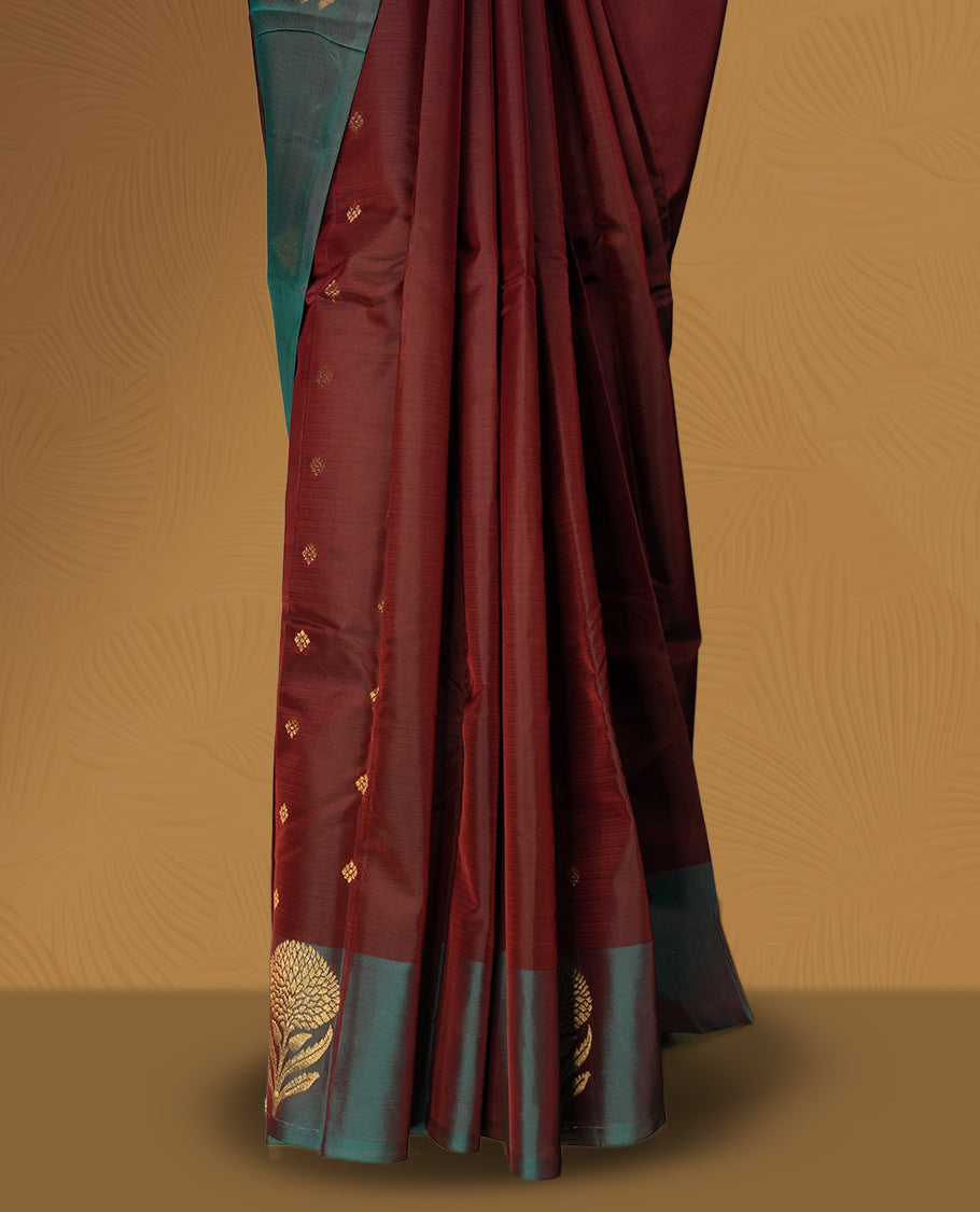 Dark maroon colour soft silk saree with a stunning maroon and teal green colour double shaded border, rich golden zari motifs, and a paired matching blouse.