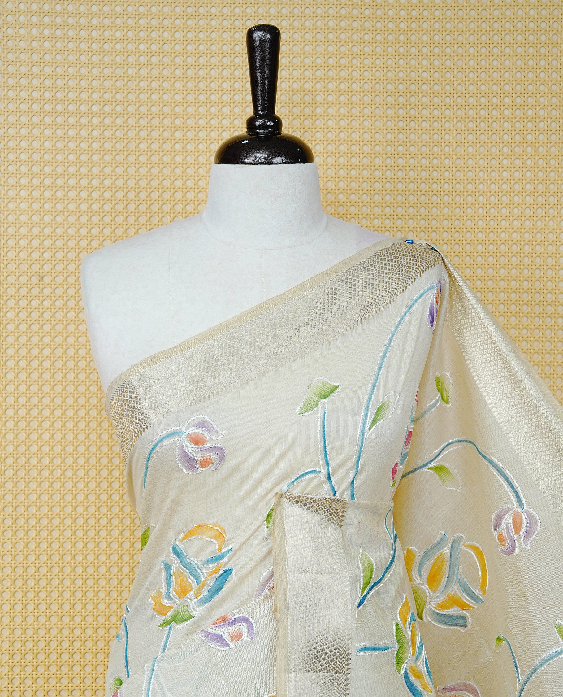 Cream Colour Tissue Kerala Saree Featuring Floral Kodi Threadwork Across The Body, Enhanced With A Light Gold Zari Border And A Light Blue Floral Pallu, Finished With Gold Tassels And A Matching Blouse Piece
