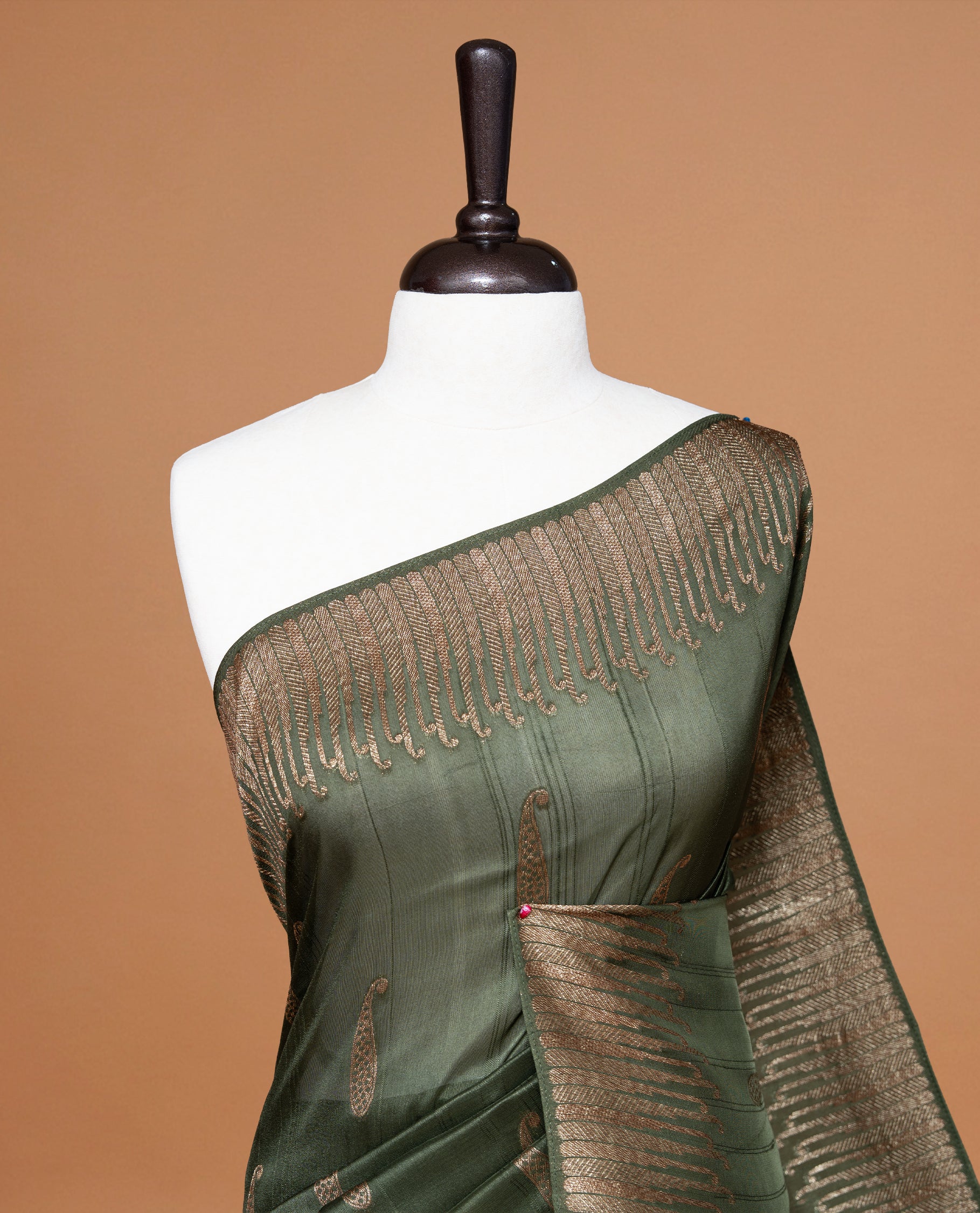Green colour Semi Banaras Tussar Georgette Featuring Gold zari Leaf pattern on body, Finished with Gold zari border and paired with matching blouse piece.