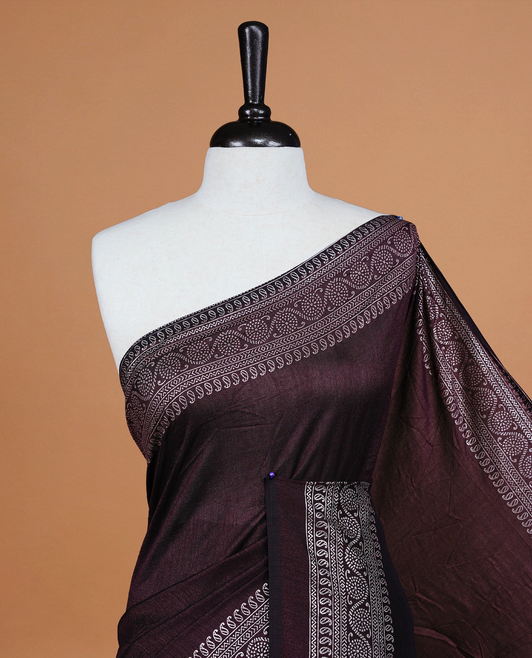 Chocolate colour semi silk saree featuring Elegant plain body with fancy border, comes with matching self colour blouse piece.