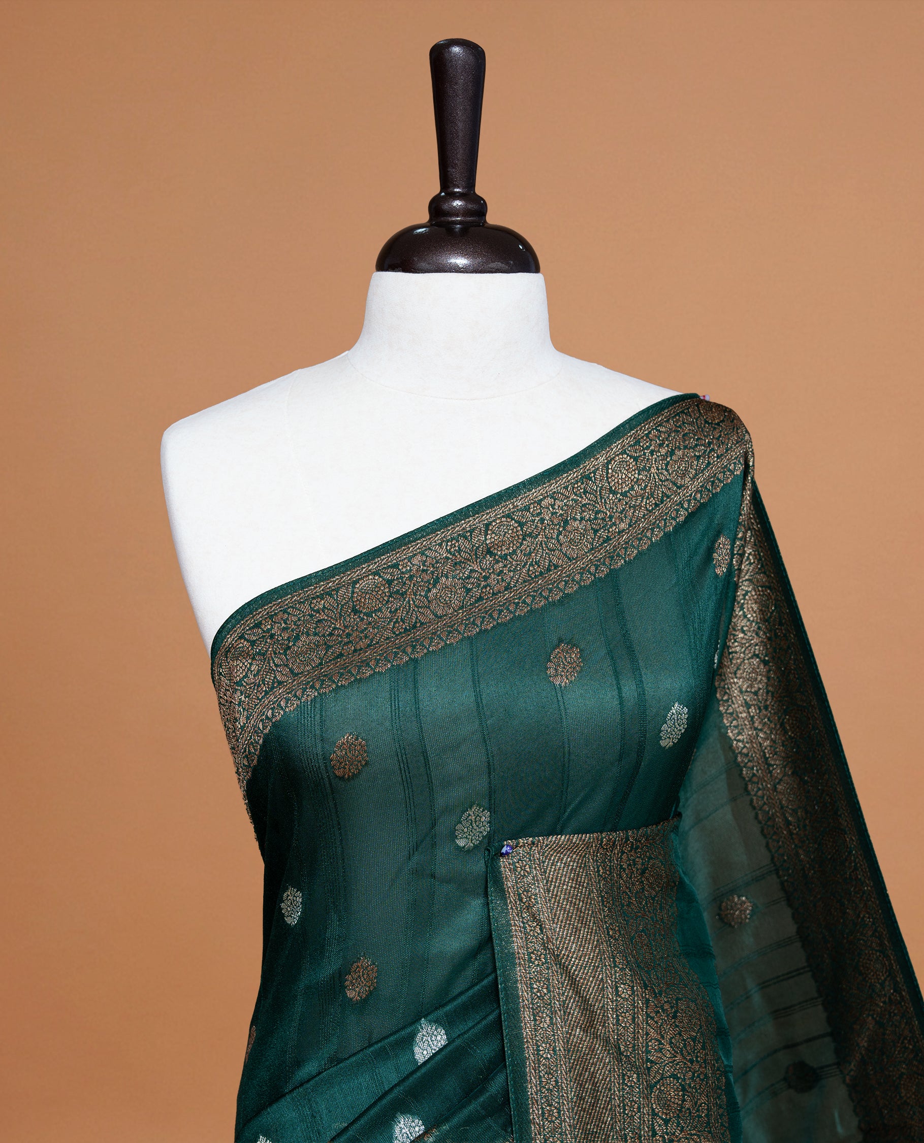 Green colour Semi banaras tussar georgette Saree featuring Antique zari motifs on body, enhanced with antique zari border, paired with a matching blouse piece.