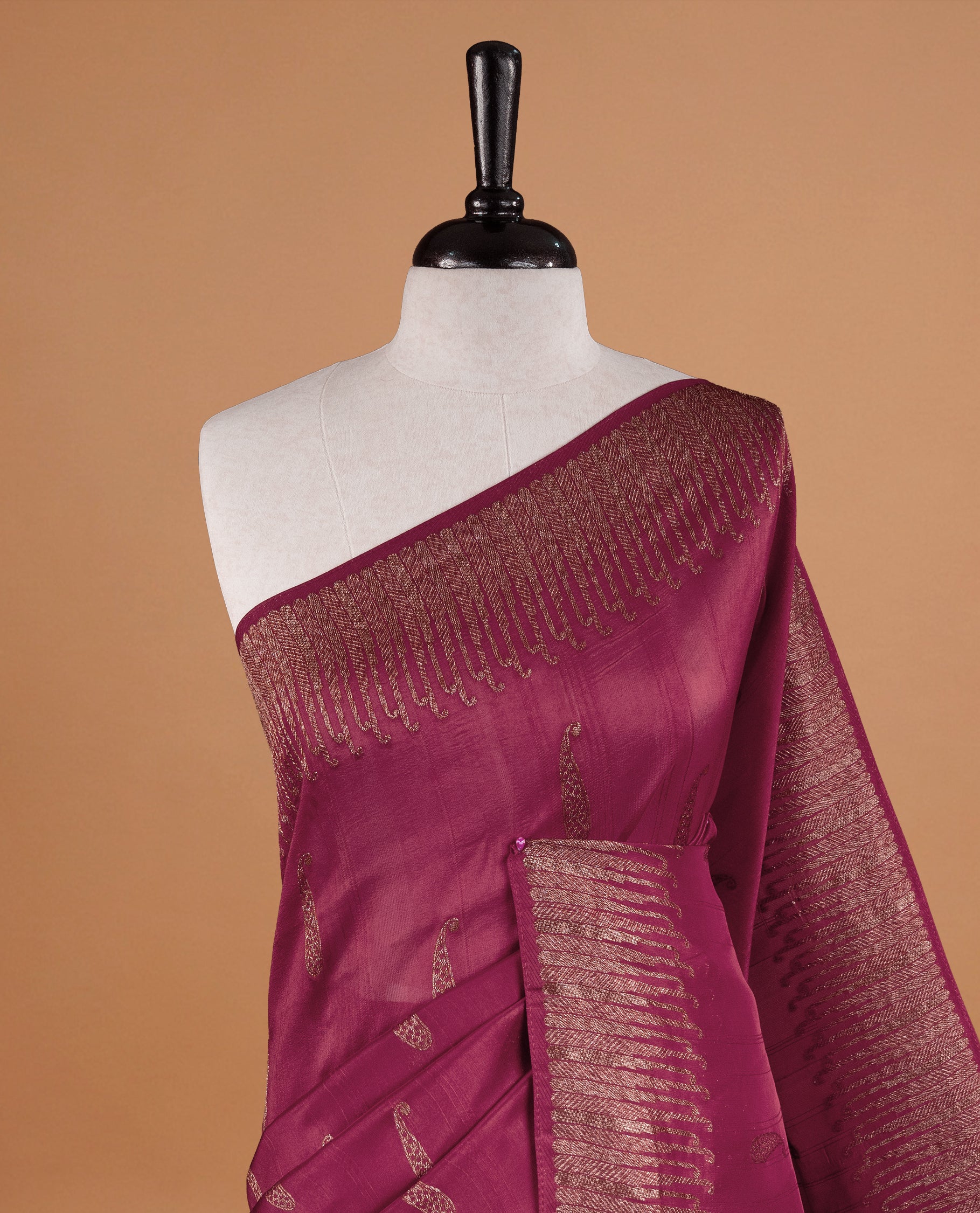 Dark Rouge colour Semi Banaras Tussar Georgette Featuring Gold zari Leaf pattern on body, Finished with Gold zari border and paired with matching blouse piece.