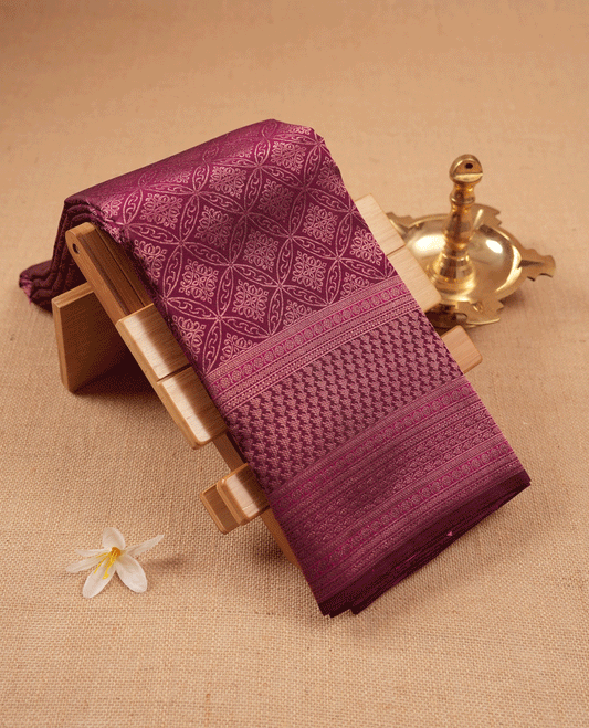 Mulberry purple Colour Manthrakodi saree featuring Antique Zari geometric brocade pattern on the body, complemented by a brocade border and a matching self coloured blouse.