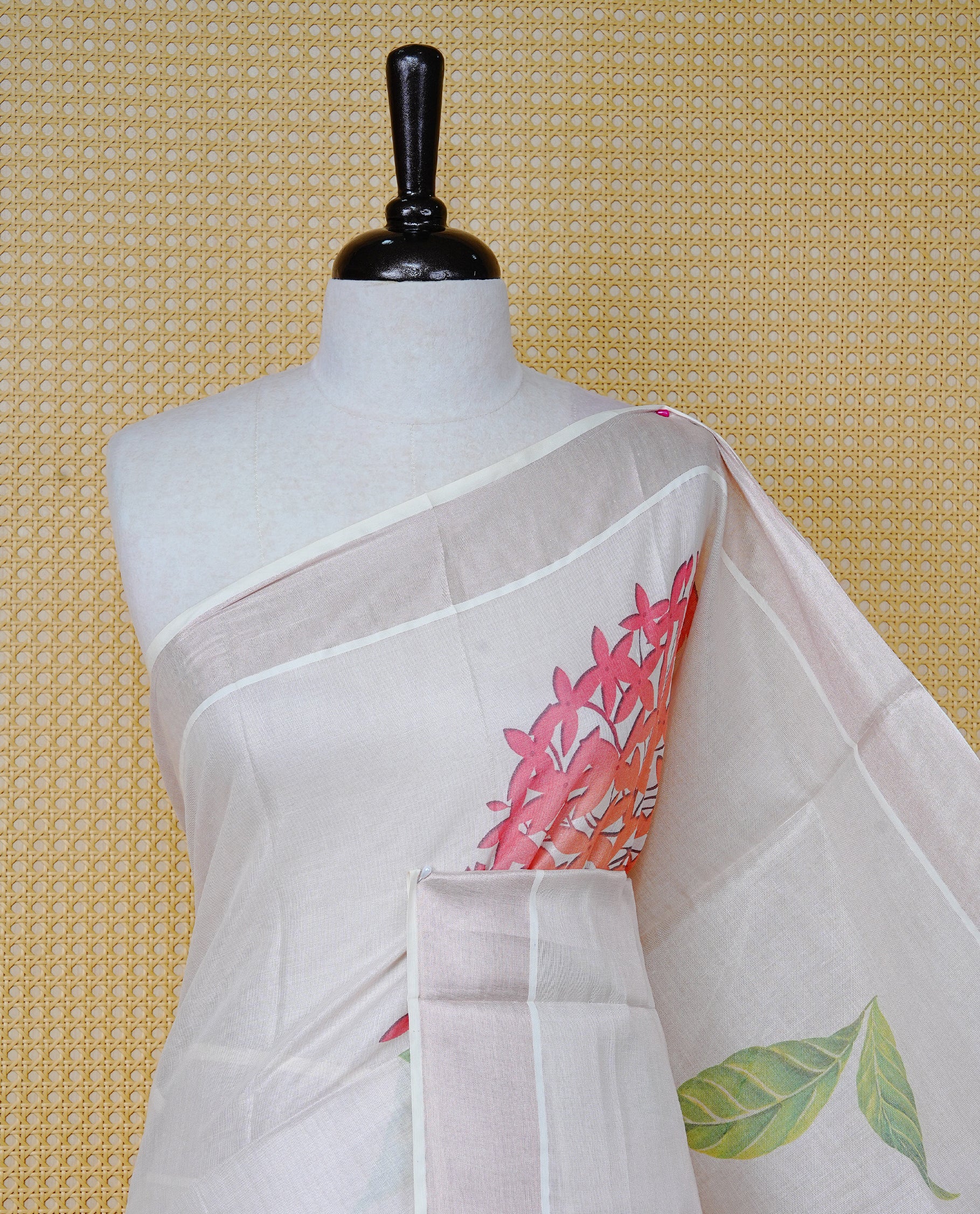 Cream Colour Tissue Kerala  Saree Featuring A Digital Floral Printed Body &  Pallu, , Beautifully Enhanced With A Classic  Rose Gold Zari Border And Red &  Green  Tassels, Paired With A Matching Blouse Piece.