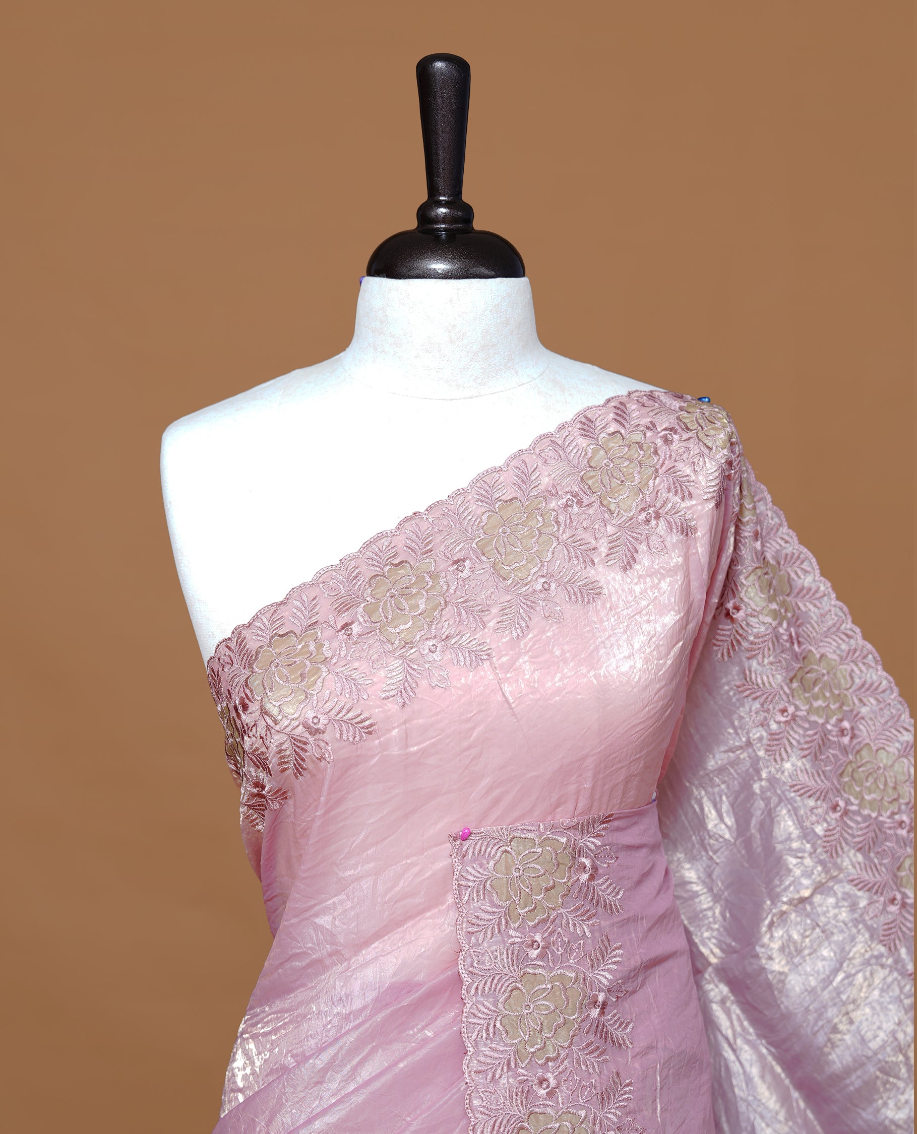 Pastel pink colour Crush Organza Featuring Plain body, Enrich with Floral thread pattern & scalp border, paired with matching blouse piece.