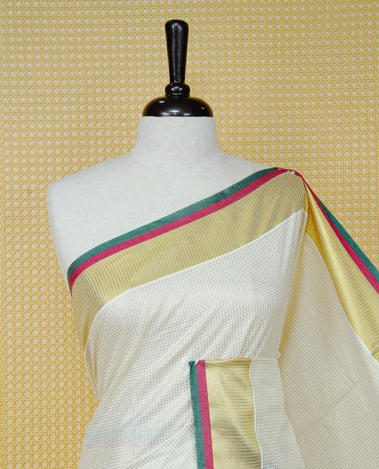 Cream colour cotton Kerala saree Featuring Gold zari Checks across the body, complemented by Classy gold zari with an Maroon  &  Green Border & pallu, paired with a matching blouse piece.