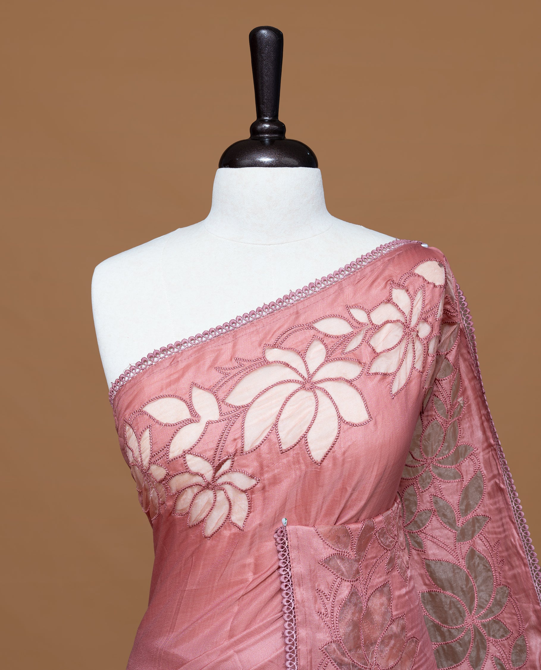 Pastel Peach colour Designer saree Featuring Elegant plain body, enhance with thread Lotus Pattern with lace border, paired with matching blouse piece.