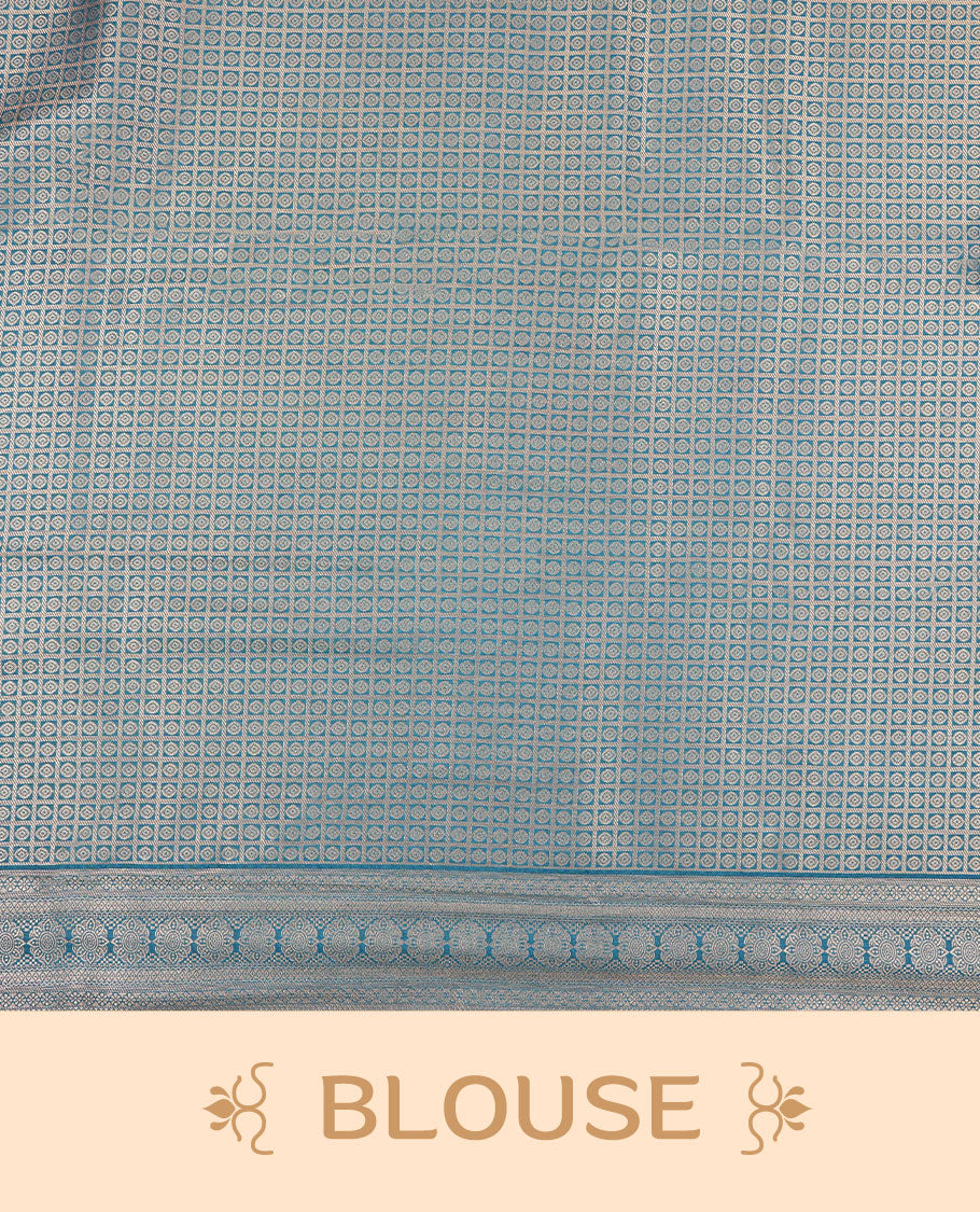 Teal colour semi silk brocade saree featuring intricate Gold patterns across the body, complemented by a Self colour woven border and pallu, paired with a matching blouse.