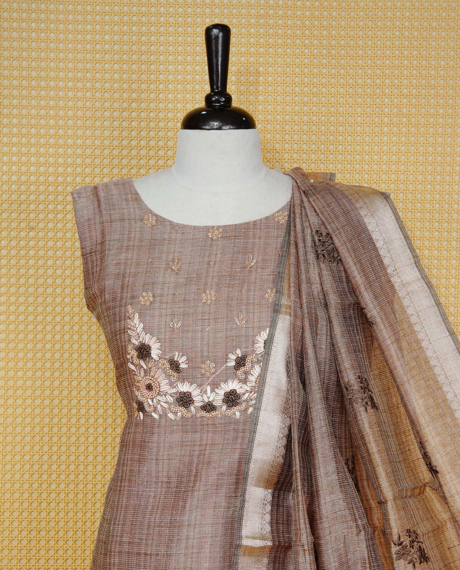 Brown colour Tissue Churidar Set featuring delicate floral embroidery and subtle bead detailing on the yoke, paired with matching solid pants and dupatta.