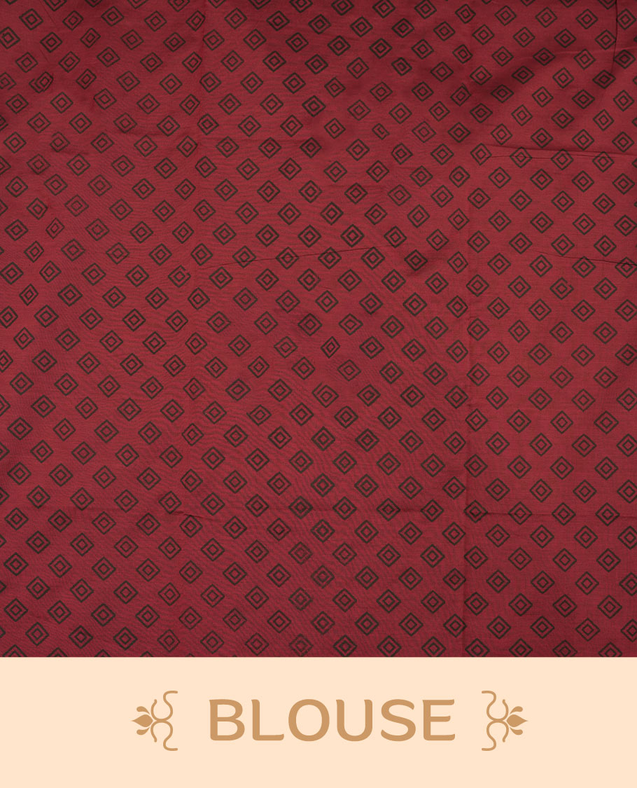 Dark red colour poly cotton saree with black temple motifs on the body, paired with a matching with black woven traditional border, and a coordinated all‑over geometric printed blouse piece.