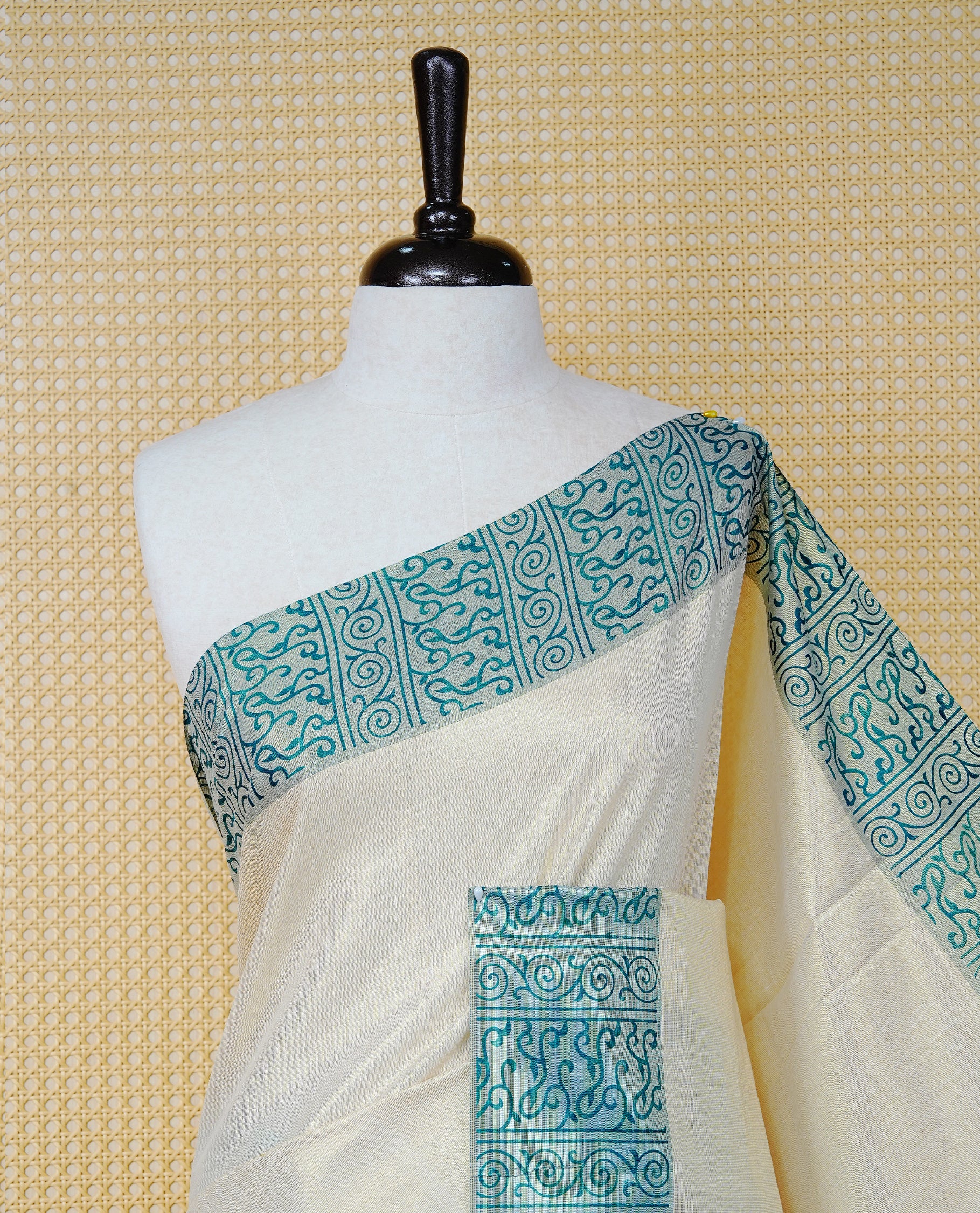 Cream Colour Tissue Kerala Saree Featuring a Plain Body, Enhanced with Sea Green Block  Printed Borders, a Sea Green and Gold Zari Pallu, Sea Green Tassels, and a Matching Blouse Piece.