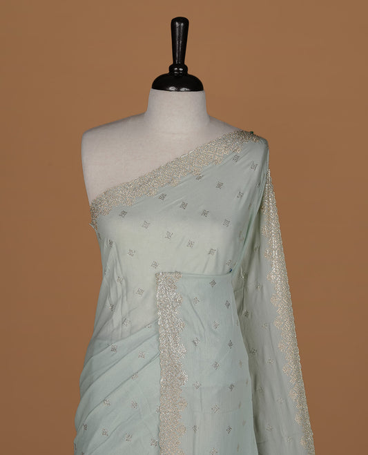 Mint colour organza designer saree featuring Gold stone motifs on body, highlighting light weight stone worked border, paired with matching blouse piece.