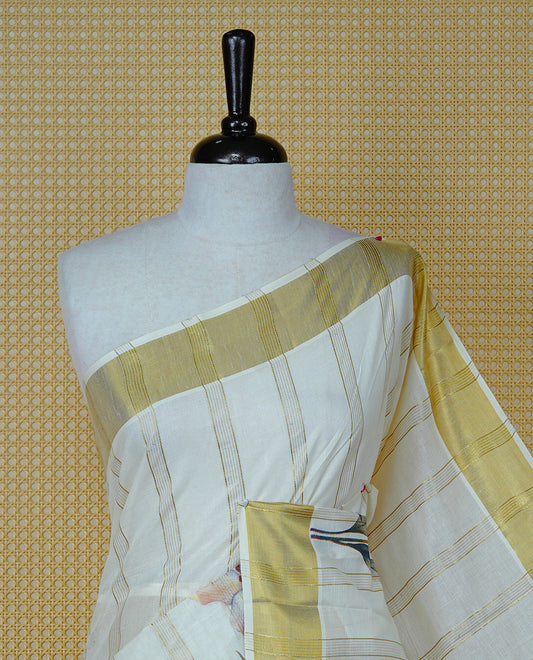 Cream Colour Cotton Kerala Sree Featuring Gold Zari Stripes On Body, Enrich Gold Zari With Floral Printed Border & Pallu, Paired With Matching Blouse Piece.