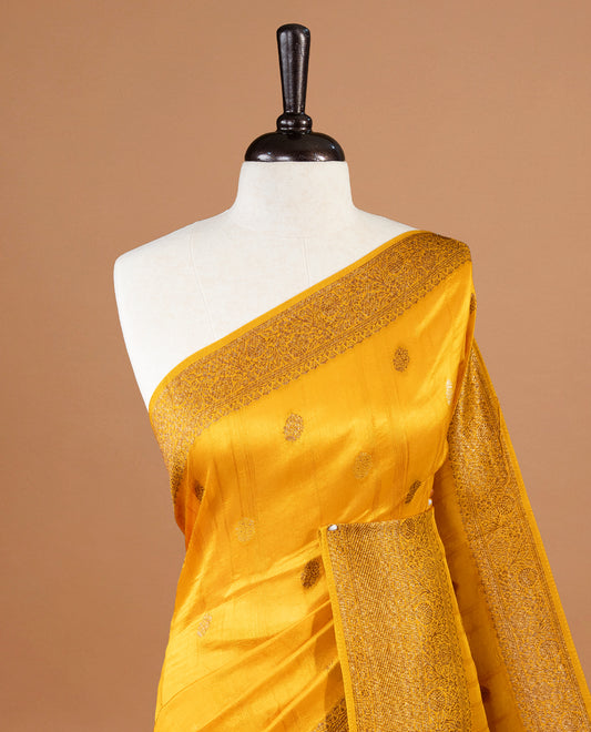 Yellow colour Semi banaras tussar georgette Saree featuring Antique zari motifs on body, enhanced with antique zari border, paired with a matching blouse piece.